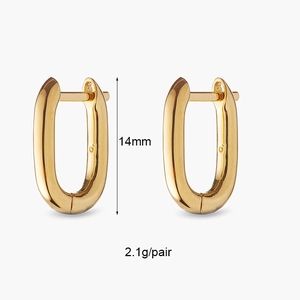 Macro shot of 14mm gold-plated huggie earrings with a sleek oval U-shaped design