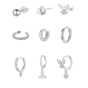 Nine-piece silver earring set featuring butterfly studs, zircon hoops and trendy ear cuffs