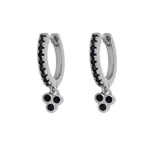 Macro detail of silver clover hoop earrings featuring black stones and zircon inlay