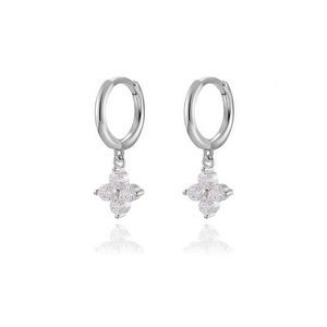 Macro view of silver four-leaf clover earrings featuring pavé-set zircon stones