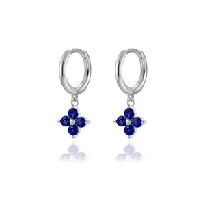Detailed close-up of silver clover drop earrings with blue zircon and mirror reflection
