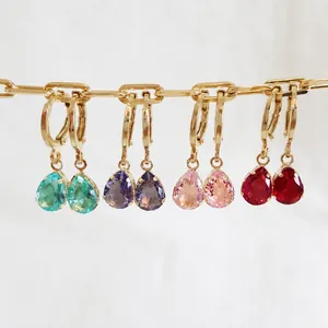 Detailed set of four teardrop gemstone earrings with gold prong settings on a chain