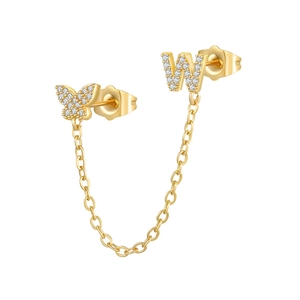Detail of 18K gold butterfly and letter W earrings connected by a delicate chain link