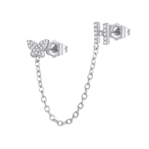 Close-up of zircon butterfly and letter H stud earrings connected by a fine silver chain