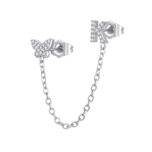 Close-up of silver butterfly and letter K stud earrings with zircon stones and chain