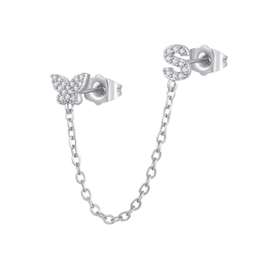 Macro detail of silver S925 link earrings with cubic zirconia butterfly and letter S charm