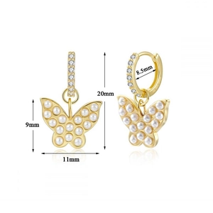 Detail view of gold butterfly hoop earrings with white pearls and zirconia accents