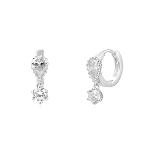 Macro detail of silver earrings with pear and round cubic zirconia in prong setting