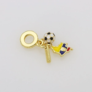 Macro shot of Colombia map charm and football pendant on a gold plated snake chain