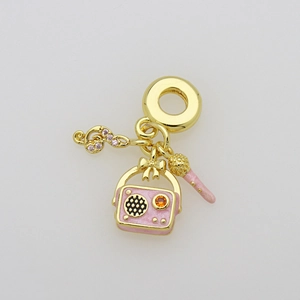 Détail macro du pendentif musical doré avec radio rose et notes pour bracelet