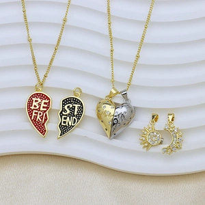 Detail of Best Friend heart pendants with sun and moon designs on white silk