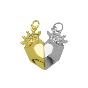 Detailed macro of magnetic heart crown pendants with zircon inlay in gold and silver finish