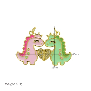Macro shot of magnetic cartoon dinosaur pendants with gold crown and crystal heart