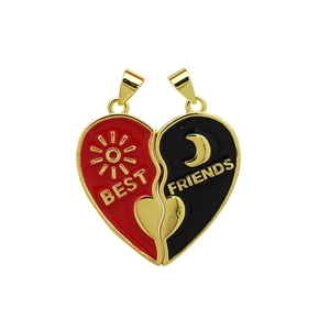 Close-up of magnetic sun and moon heart pendants with Best Friends engraving