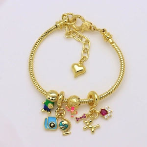 Gold snake chain bracelet featuring enamel globe, camera, and balloon dog charms