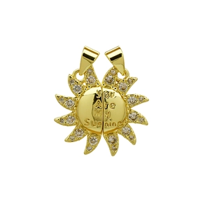 Macro detail of sun-shaped pendant with You Are My Sunshine engraving and zircon inlay