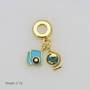 Golden travel charm with light blue camera and green enamel globe pendant, 2.7g weight