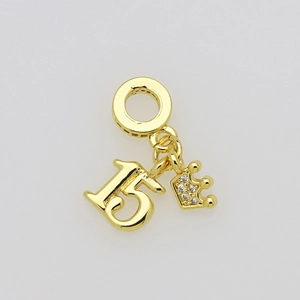 Detailed macro view of a gold-plated number 15 charm with a sparkling pavé crown