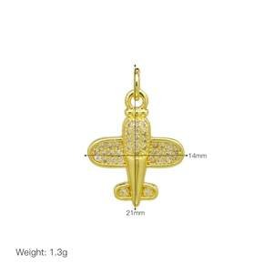 Macro shot of 18K gold plated airplane pendant with cubic zirconia details and 21mm size