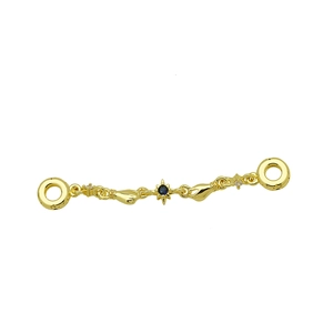 Golden hands holding an eight-pointed star pendant with blue gemstone for snake chain