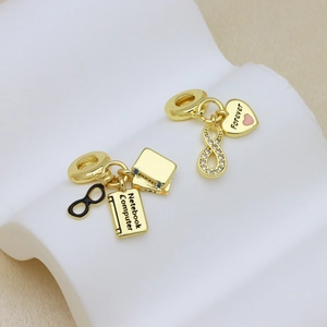 18K gold plated charms with infinity heart and book motifs on a satin background