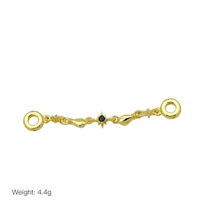 Detail of a 4.4g gold metal jewelry charm with blue gemstone and relief hand design