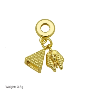 Detailed golden Egyptian pendants featuring a textured pyramid and pharaoh face charm