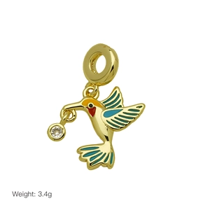 Detailed hummingbird charm pendant in gold finish with blue enamel and 3.4g weight