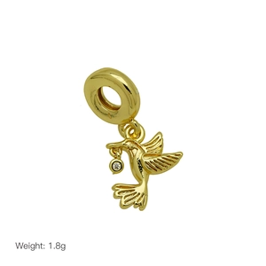 Macro shot of 1.8g golden hummingbird charm with white zircon for snake chain bracelets