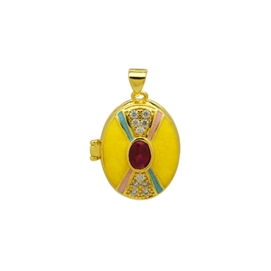 Macro detail of 18K gold-plated oval locket with yellow enamel and red center stone