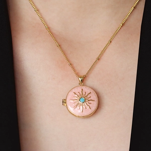 Pink enamel sunburst heart locket necklace with turquoise stone and gold bead chain