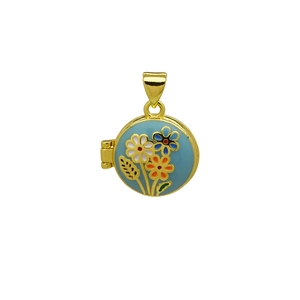 Detalle macro del colgante ovalado de oro de 18K con diseño de flores en esmalte azul