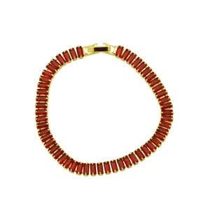 Macro shot of gold plated bracelet with square cut dark red cubic zirconia stones