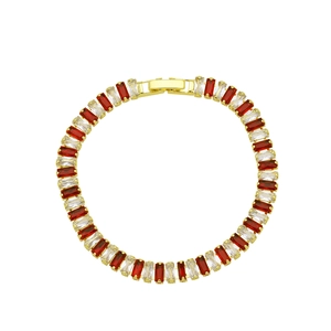 Macro view of 18K gold plated tennis bracelet with red and white baguette cut zircons