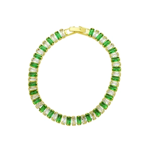 Macro shot of 18K gold plated bracelet with square emerald green stones and clear zircons