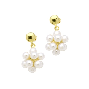 Close-up of gold pearl earrings featuring a floral cluster of round white pearls