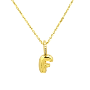 Detail of gold letter F pendant necklace with pavé cubic zirconia on the bail