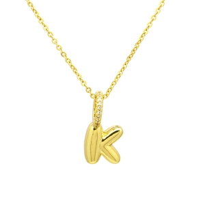 Close-up of golden balloon-style letter K pendant with sparkling zircon set on a fine chain