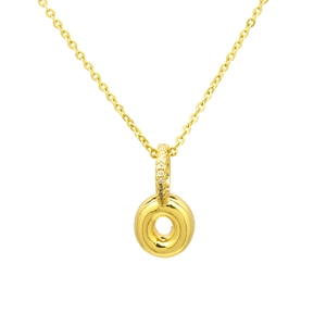 Macro detail of gold-plated pendant showing micro-pave zircon setting and glossy circle charm