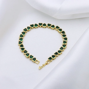 Elegant gold heart bracelet featuring vibrant green zircon stones with a secure folding clasp