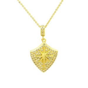 Macro shot of gold shield pendant with pavé zircon stones and a central hexagram star motif