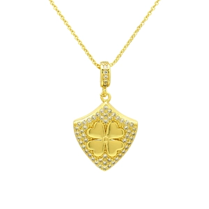 Detailed macro view of the gold shield pendant with clover design and pave zircons