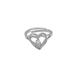 Macro view of silver heart ring featuring pavé stones and a central letter G detail