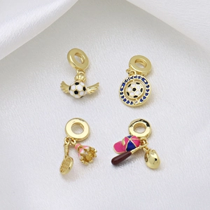 Golden sports charms featuring soccer balls, badminton rackets, and baseball gear motifs