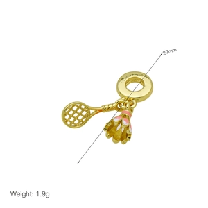 Macro shot of gold tennis racket and pink enamel shuttlecock charms with measurements