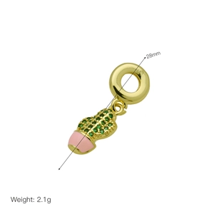 Macro detail of a 28mm gold cactus charm with green crystals and pink enamel base
