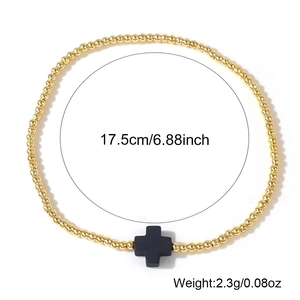 Bracciale minimalista di perle dorate con croce nera, circonferenza di 17,5 cm.