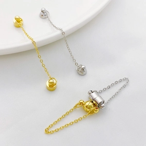 Detail of 14K gold and silver magnetic jewelry clasps with safety chain for necklaces