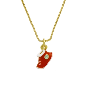 Detail of red sneaker pendant on a gold box chain necklace with enamel finish