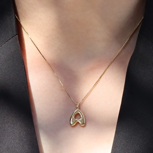 Golden puffy balloon initial A pendant necklace for women on professional black attire